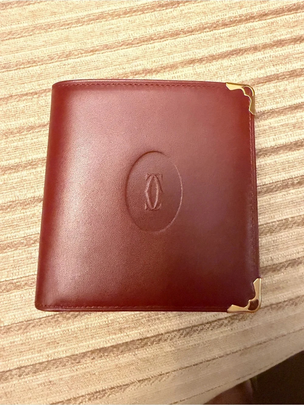 Cartier Burgundy Leather Bifold Wallet with Gold Corner Accents